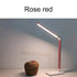 Rose red LED Desk Lamp with a slim adjustable arm, matte finish, and bright white light illuminating a surface