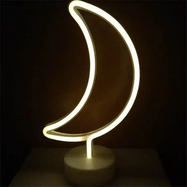 LED Neon Light shaped like a crescent moon with warm white glow on a clear round base