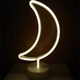 LED Neon Light shaped like a crescent moon with warm white glow on a clear round base