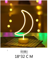 LED Neon Light shaped like a crescent moon with warm yellow glow on a white base, ideal for decorative indoor use