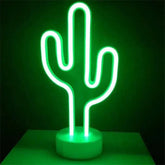 LED Neon Light in the shape of a cactus with bright green glow on a white circular base against a dark background