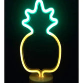 LED Neon Light in the shape of a pineapple with yellow and green vibrant glowing PVC tubes mounted on a clear base