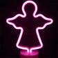 LED Neon Light shaped like an angel glowing vibrant pink on a clear round base ideal for decorative use