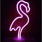 LED Neon Light shaped like a pink flamingo with vibrant glow on a round clear base for decorative use indoors