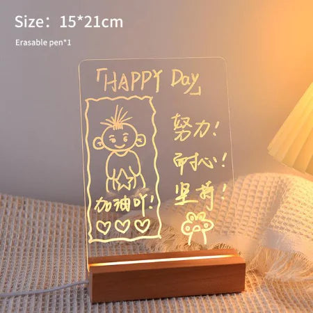 LED Note Board with clear acrylic panel and wooden base displaying illuminated handwritten messages in yellow light