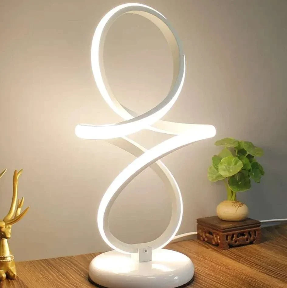 LED Table Lamp with modern white LED light in a looping figure-eight design on a round base emitting ambient glow