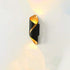 LED Waterproof Outdoor Wall Lamp with a sleek black and gold curved metal design emitting warm light upward and downward