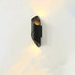 LED Waterproof Outdoor Wall Lamp in black metal with a twisted cylindrical shape and warm light glowing from top and bottom