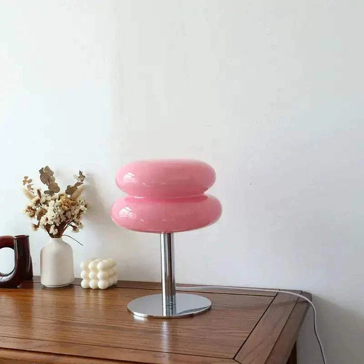 Macaron LED Lamp with a glossy pink macaron-shaped shade, chrome stem and round metal base
