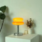Macaron LED Lamp with two stacked orange rounded shades, a chrome stem and circular metal base