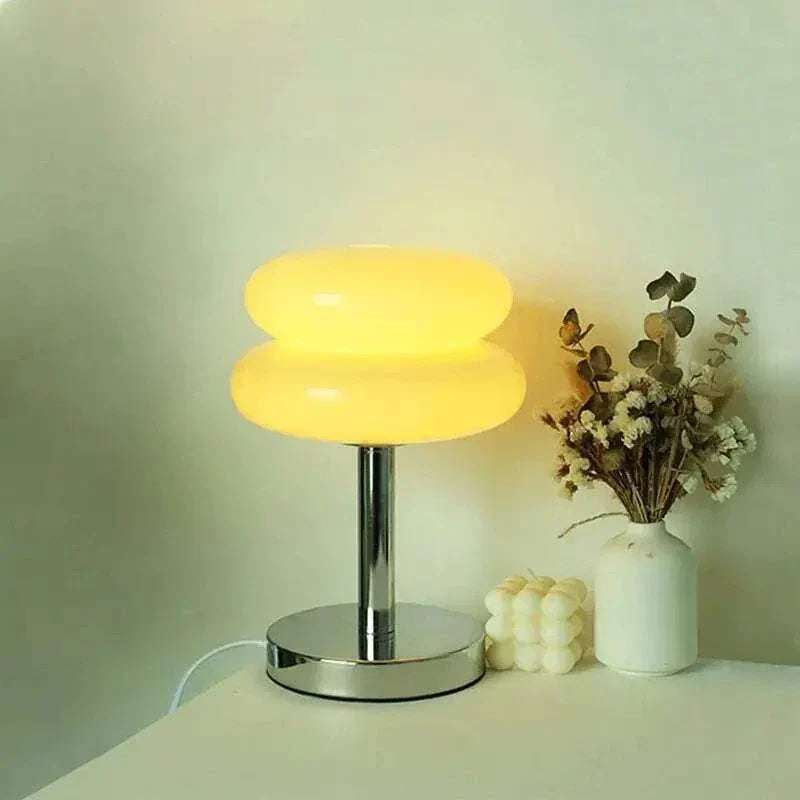 Macaron LED Lamp with a glossy yellow double-disc shade, chrome metal stem, and round reflective base