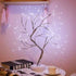 Mini Christmas Tree LED lamp with flexible copper wire branches wrapped in silver, emitting warm white LED lights