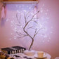Mini Christmas Tree LED lamp with flexible copper wire branches wrapped in silver, emitting warm white LED lights