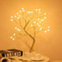 Mini Christmas Tree LED lamp with gold wire branches and warm white glowing LED lights on a white round base