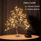 Mini Christmas Tree LED lamp with flexible silver branches decorated with 108 warm white LED lights illuminating softly