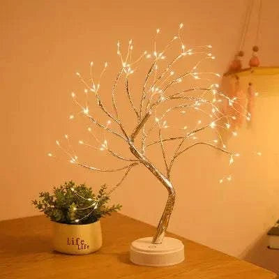 Mini Christmas Tree LED lamp with flexible silver copper wire branches and warm white LED lights on a white base