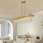 Modern Champagne Gold Kitchen Island Lamp with an oval shape featuring hanging crystal beads and a champagne gold metal frame in a living room