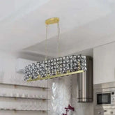 Modern Champagne Gold oval chandelier with black metal frame and clear crystal grid pattern suspended by gold chains in kitchen interior