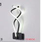 Modern Wall Lamps in black and white aluminum with acrylic LED lights, featuring a twisted, contemporary up-down design.