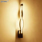 Modern Wall Lamps featuring a black aluminum body with a twisted acrylic light strip creating warm up-down illumination.