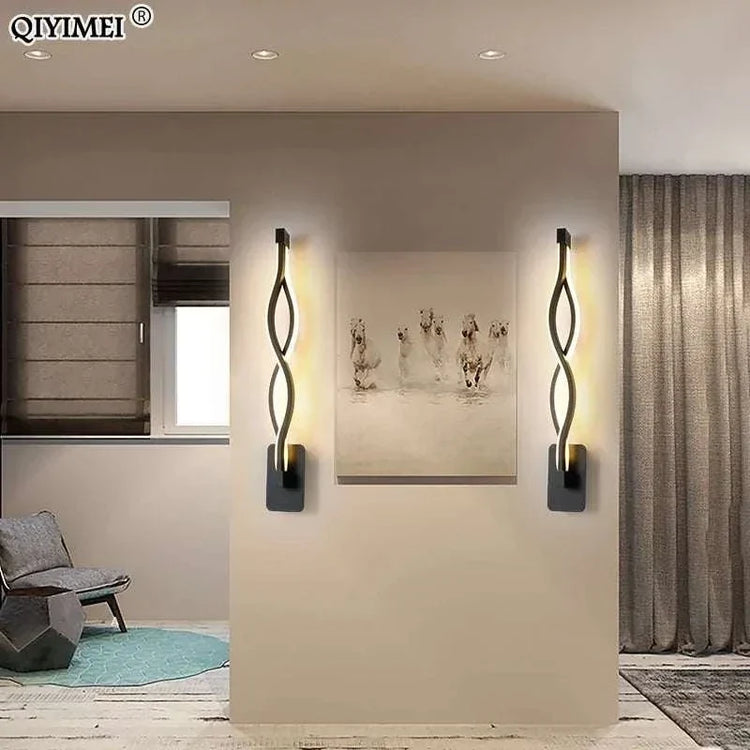 Modern Wall Lamps featuring sleek black aluminum bodies with twisted design and warm up-down LED illumination, mounted on a beige wall.