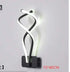 Modern Wall Lamps featuring a black aluminum base and twisting white acrylic LED light strips offering stylish up-down illumination.