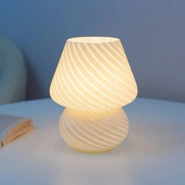 Mushroom LED Lamp with a white glass body featuring diagonal striped bubble design emitting warm light