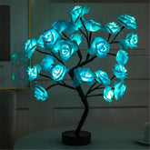 Rose Tree Lamp featuring glowing blue synthetic rose petals on a sturdy black metal branch structure with ambient lighting