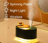 Rotating Planet Aroma Diffuser with black body, golden planet-shaped rotating top, warm night light, and wireless mist function