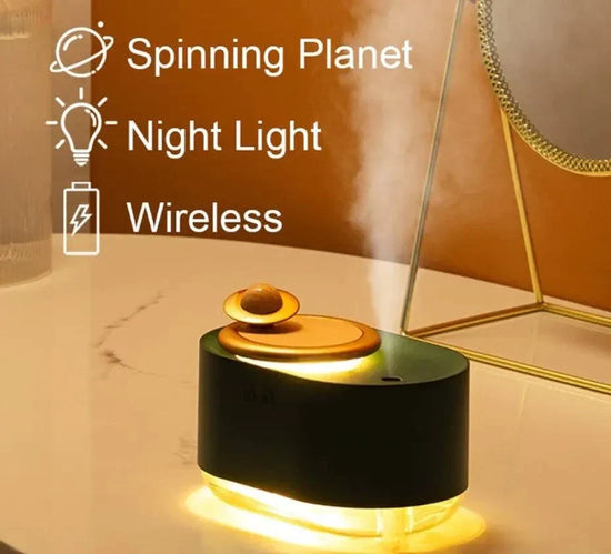 Rotating Planet Aroma Diffuser with black body, golden planet-shaped rotating top, warm night light, and wireless mist function