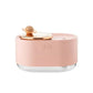 Rotating Planet Aroma Diffuser in soft pink with clear base, featuring a wooden rotating planet design and touch buttons
