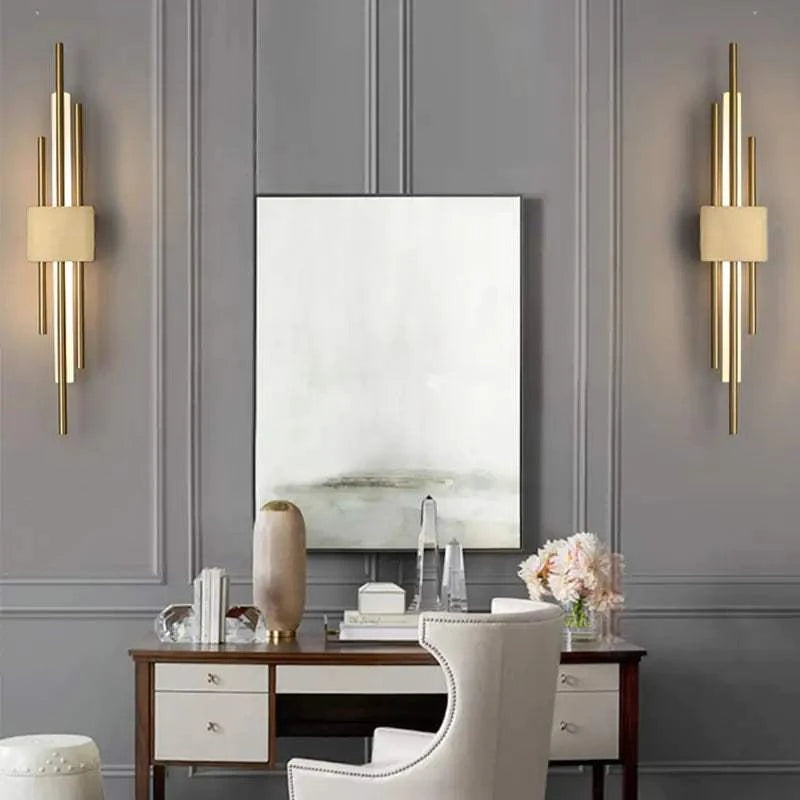 Modern LED wall lamp mounted on a wall with sleek gold and black design illuminating warm white light