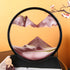 Sand Frame with black circular acrylic frame containing layered red, white, and green fine sand creating a textured mountain landscape design