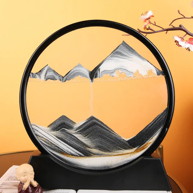 Sand Frame with black and white layered sand forming mountain and valley patterns inside a round black acrylic frame