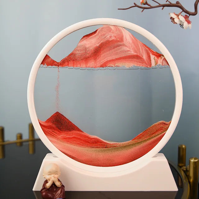 Sand Frame round white acrylic frame with red and orange multi-colored sand art forming layered patterns inside clear enclosure
