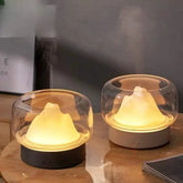 Ultrasonic Air Humidifier with black and white bases, translucent glass covers and warm yellow LED lamp mist inside
