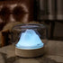 Ultrasonic Air Humidifier with beige base and transparent glass dome featuring a glowing blue LED lamp shaped like a mountain