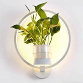 Wall Plant LED Lamp featuring a white circular frame with integrated LED lighting and a green potted plant holder at the center
