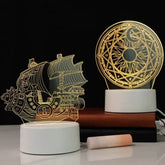 3D LED Lamp featuring intricate boat and circular geometric optical illusion designs with warm yellow light on white bases