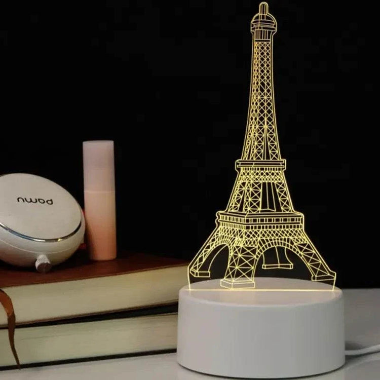 3D LED Lamp featuring an illuminated Eiffel Tower design in warm yellow light on a white base with a sleek modern look