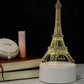 3D LED Lamp featuring an illuminated Eiffel Tower design in warm yellow light on a white base with a sleek modern look