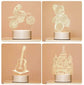 3D LED Lamp set featuring four translucent white optical illusion designs of a motorbike rider, teddy bear, guitar, and castle, each on a round white base