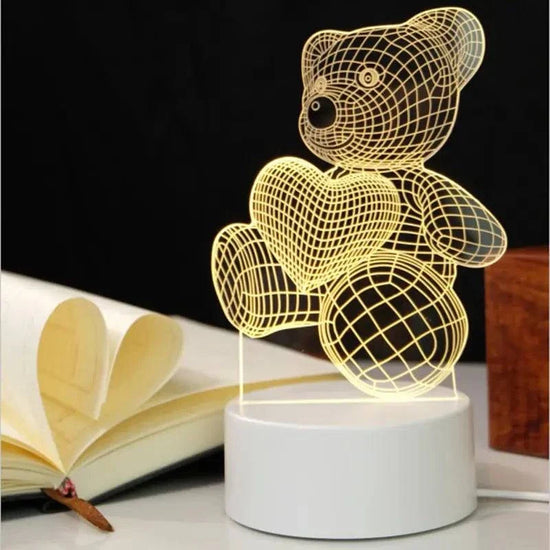 3D LED Lamp shaped like a teddy bear holding a heart, featuring a yellow optical illusion wireframe design on a white base