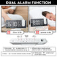 LED Digital Projection Clock with sleek black and white design, large clear digital display, and dual alarm function buttons on top panel.