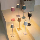 Cordless lamp set featuring minimalist design in pastel pink, blue, black, gold, white, and gray metal with warm LED lighting.