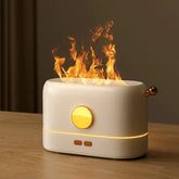 Flame Aroma Diffuser in white with gold accents, emitting realistic flame effect above sleek rectangular body on wooden surface