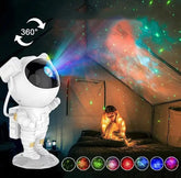 LED Astro Projector in white astronaut shape projecting colorful nebula and star patterns with 360-degree rotation effect