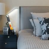 LED Study Lamp with slim black stand, angled white LED bar, and smartphone dock displaying the time