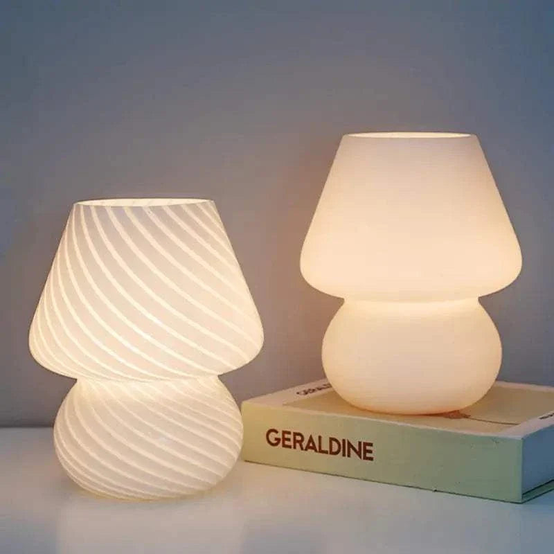 Mushroom LED Lamp set with one lamp featuring white glass and spiral pattern, and the other with smooth white glass surface glowing warmly