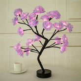 Rose Tree Lamp with black metal stem and branches featuring glowing pink synthetic flower petals providing ambient lighting